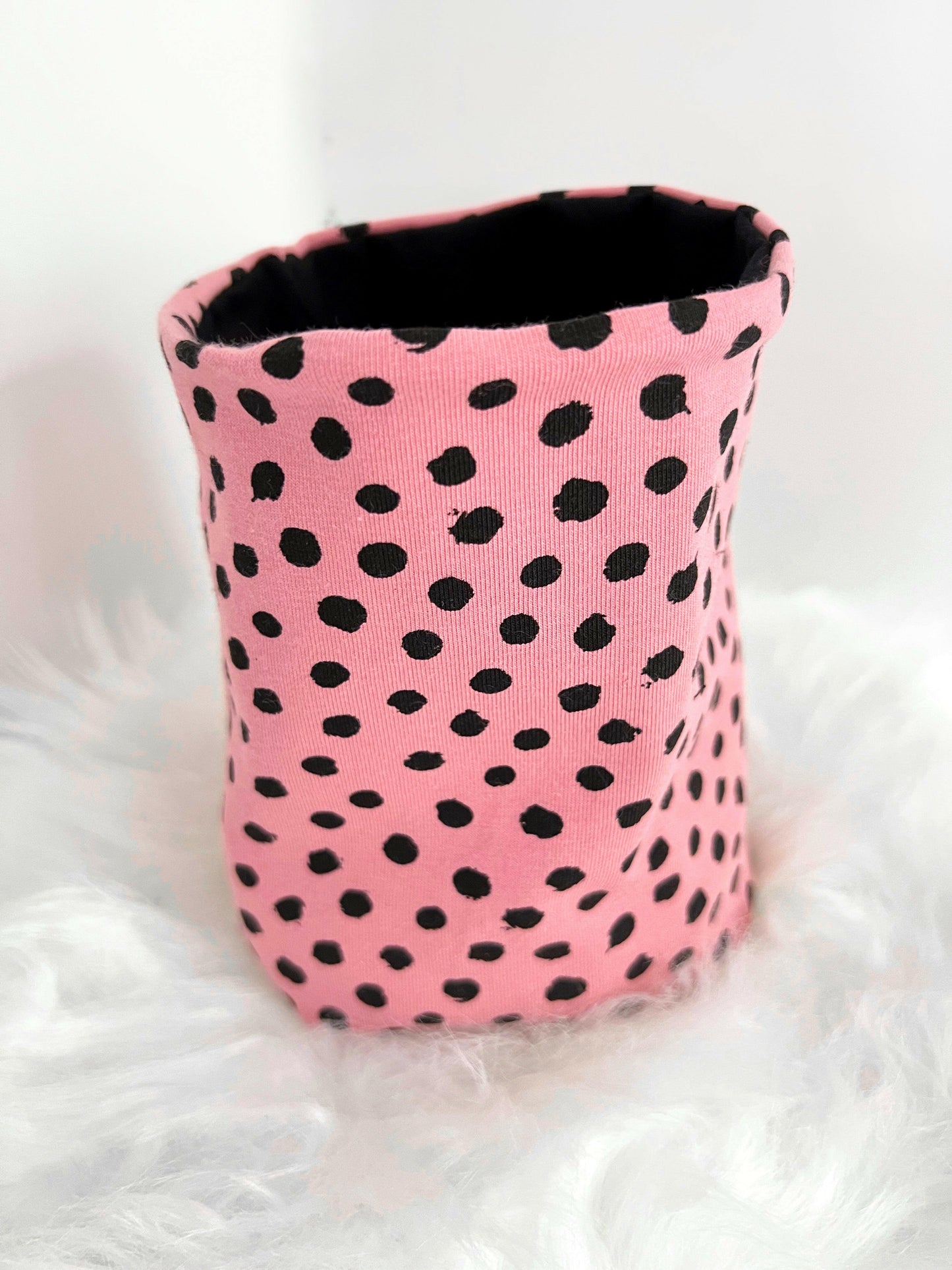 Pink and black spotty ear protecting snood