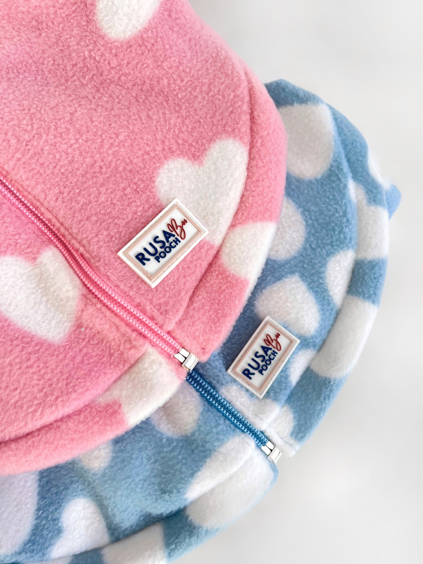 Pink and blue heart fleeces with zips