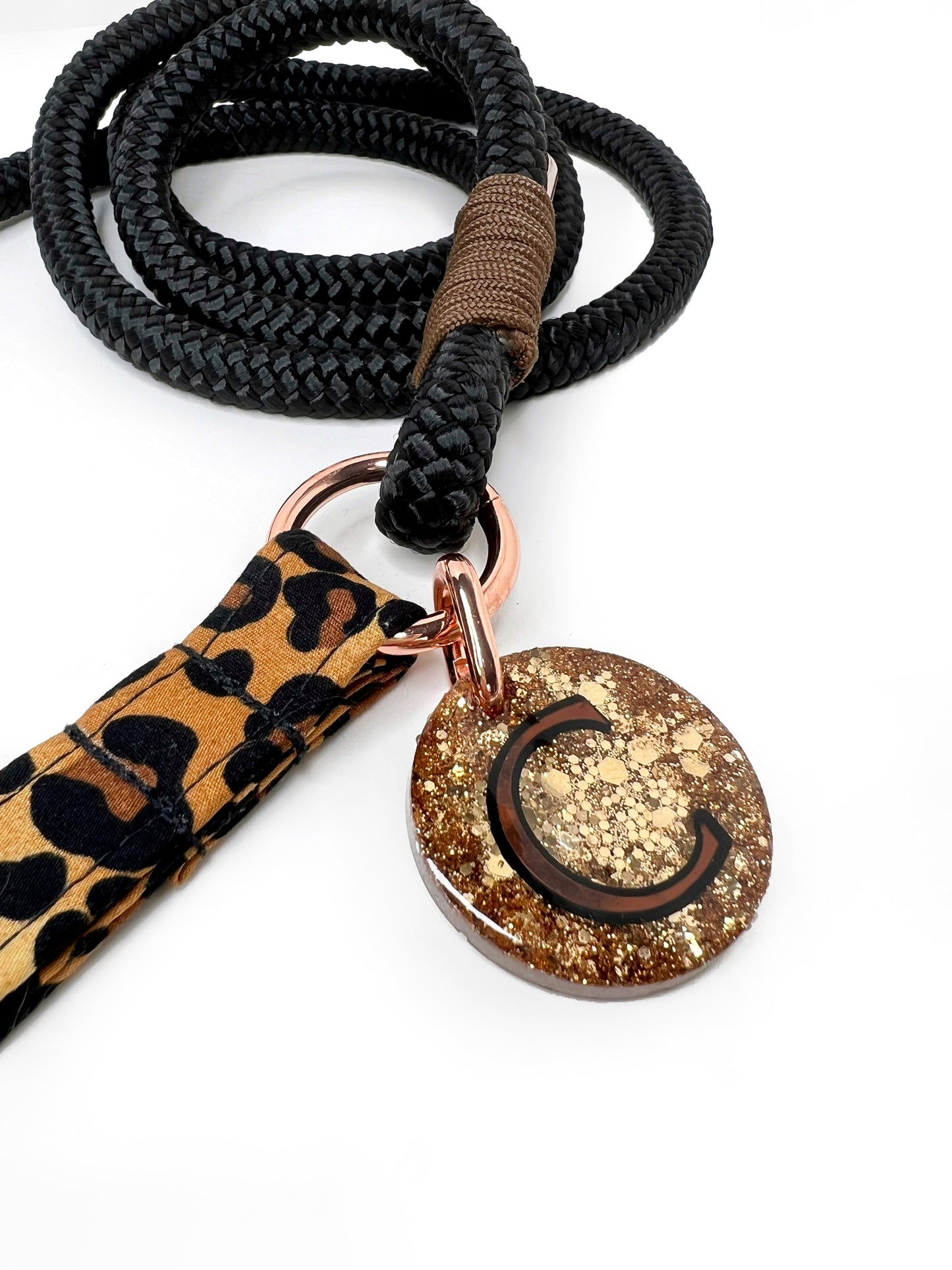 Close up of gold glitter tag on a rope lead