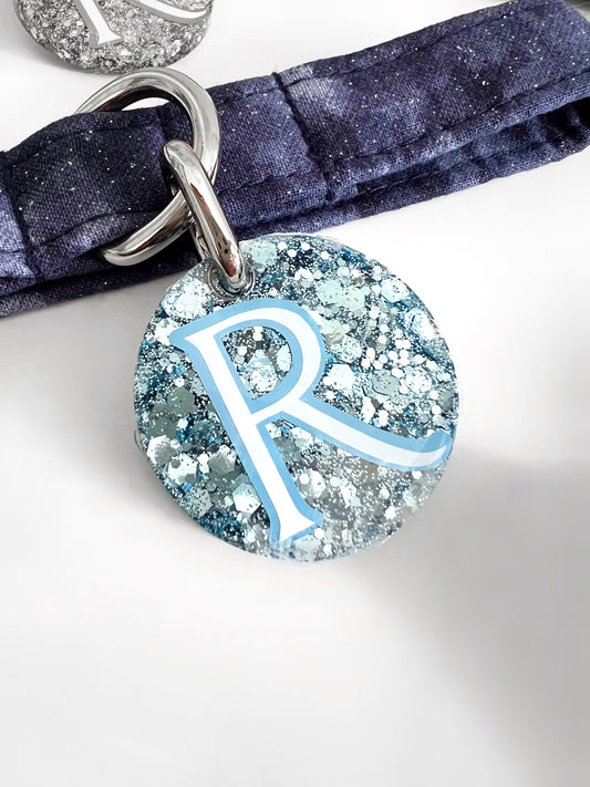 Personalised blue glitter id tag on a navy dog collar
