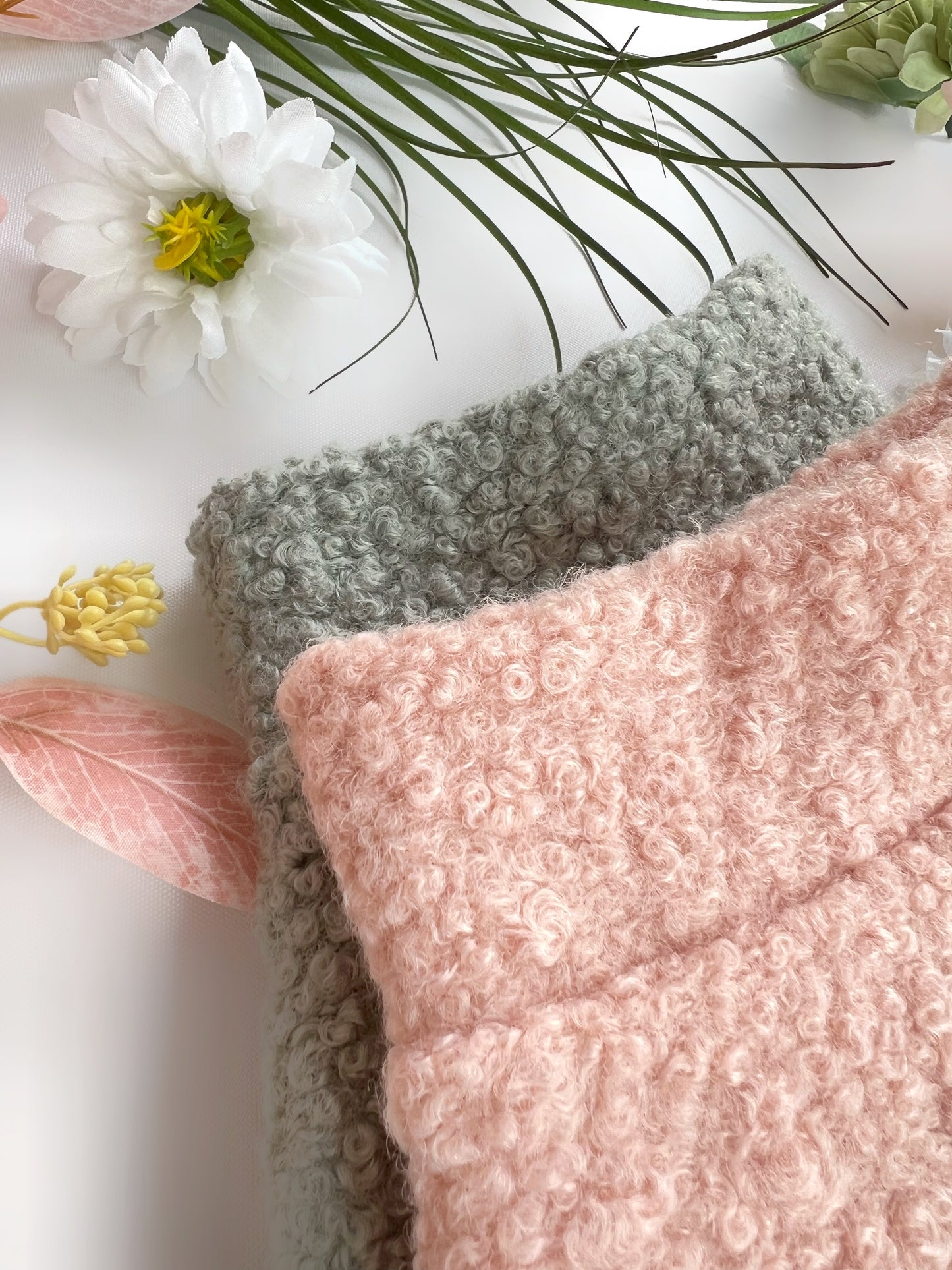 Close up of peachy pink and sage green borg jumpers