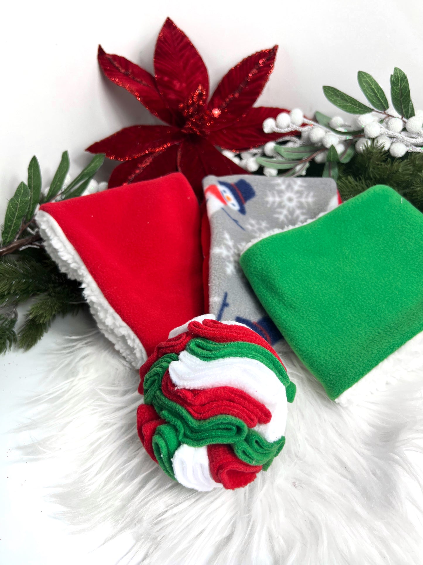 Trio of chirtsmas snoods alongside a snuffle ball