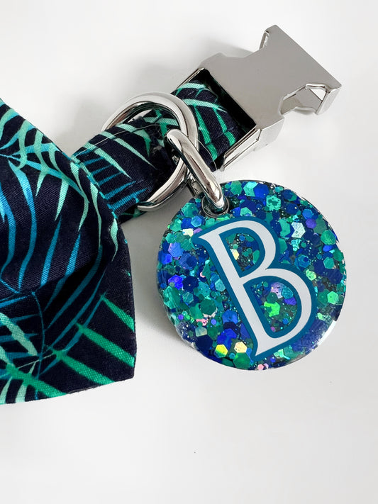 Blue and green sparkly dog tag on tropical print collar