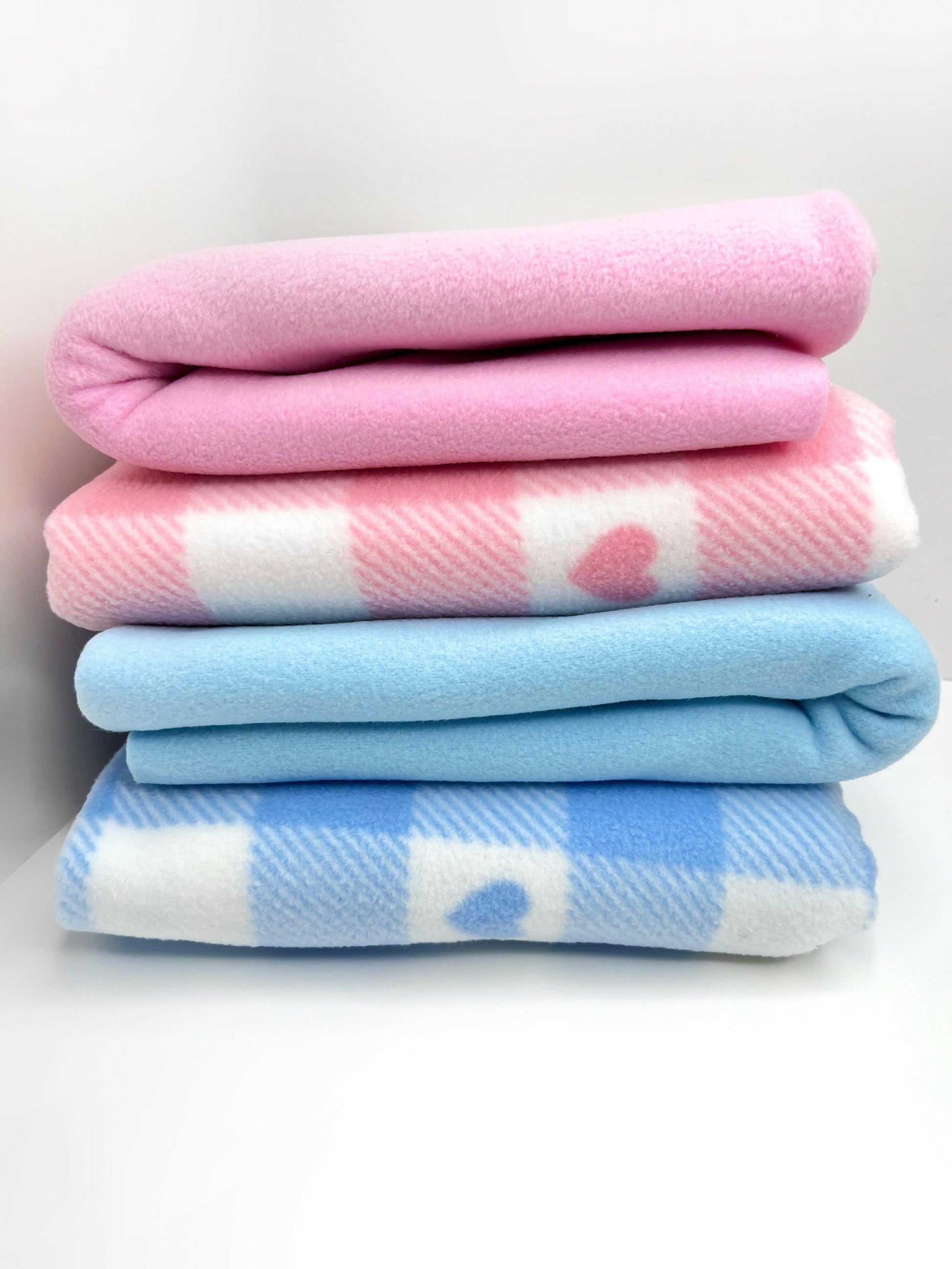 Both pink and blue checked polar fleece blankets