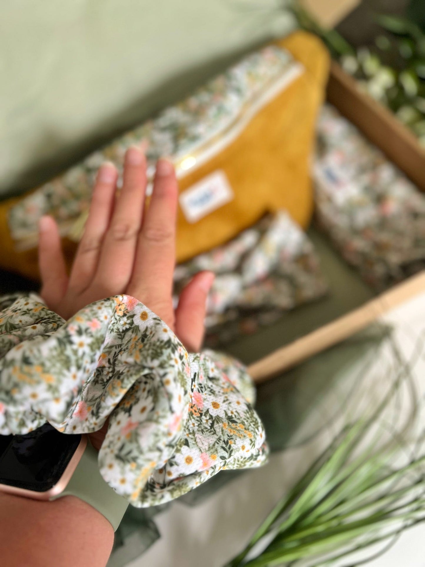 Green flower scrunchie on arm to show size 