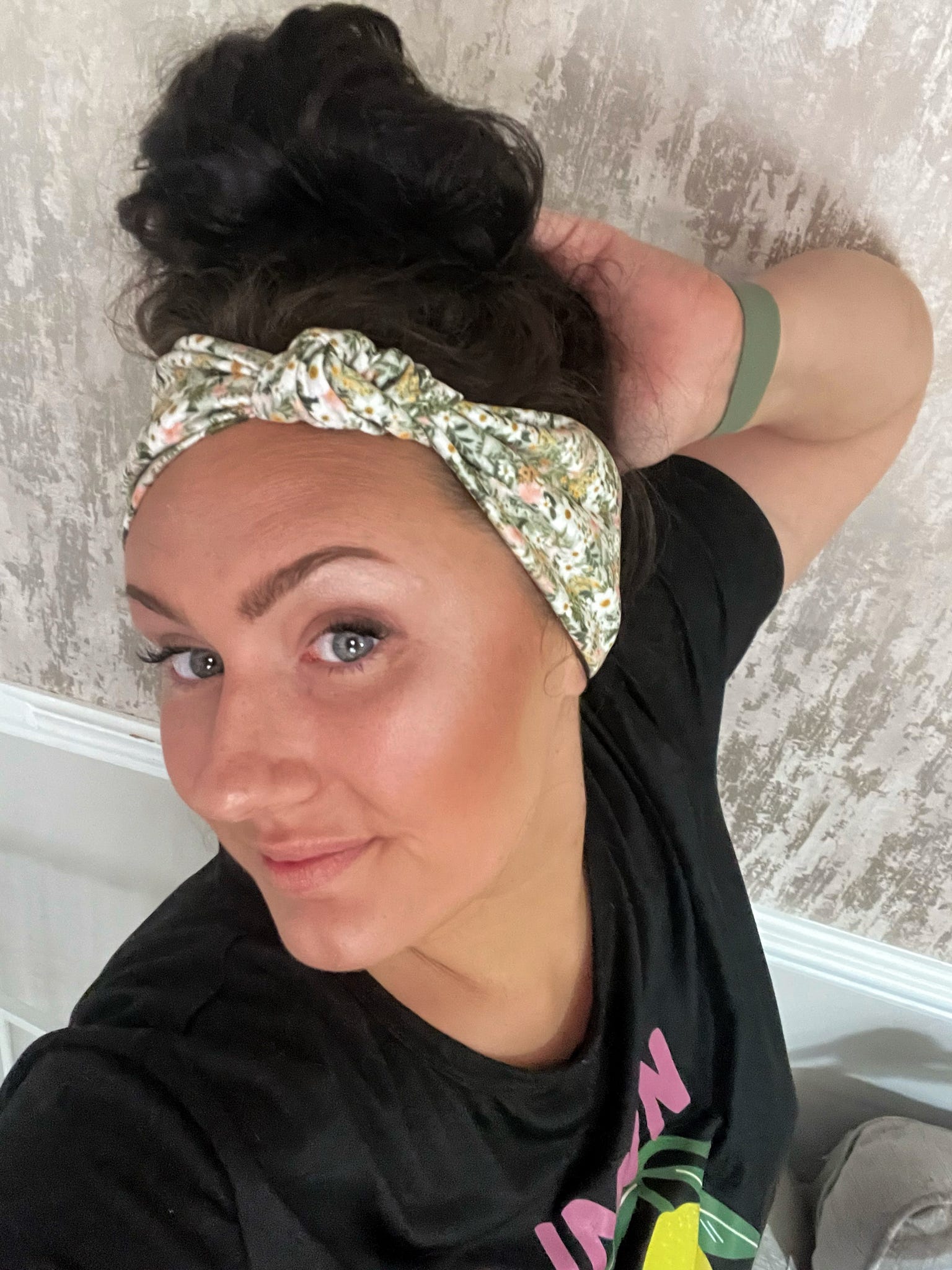Green floral headband being worn