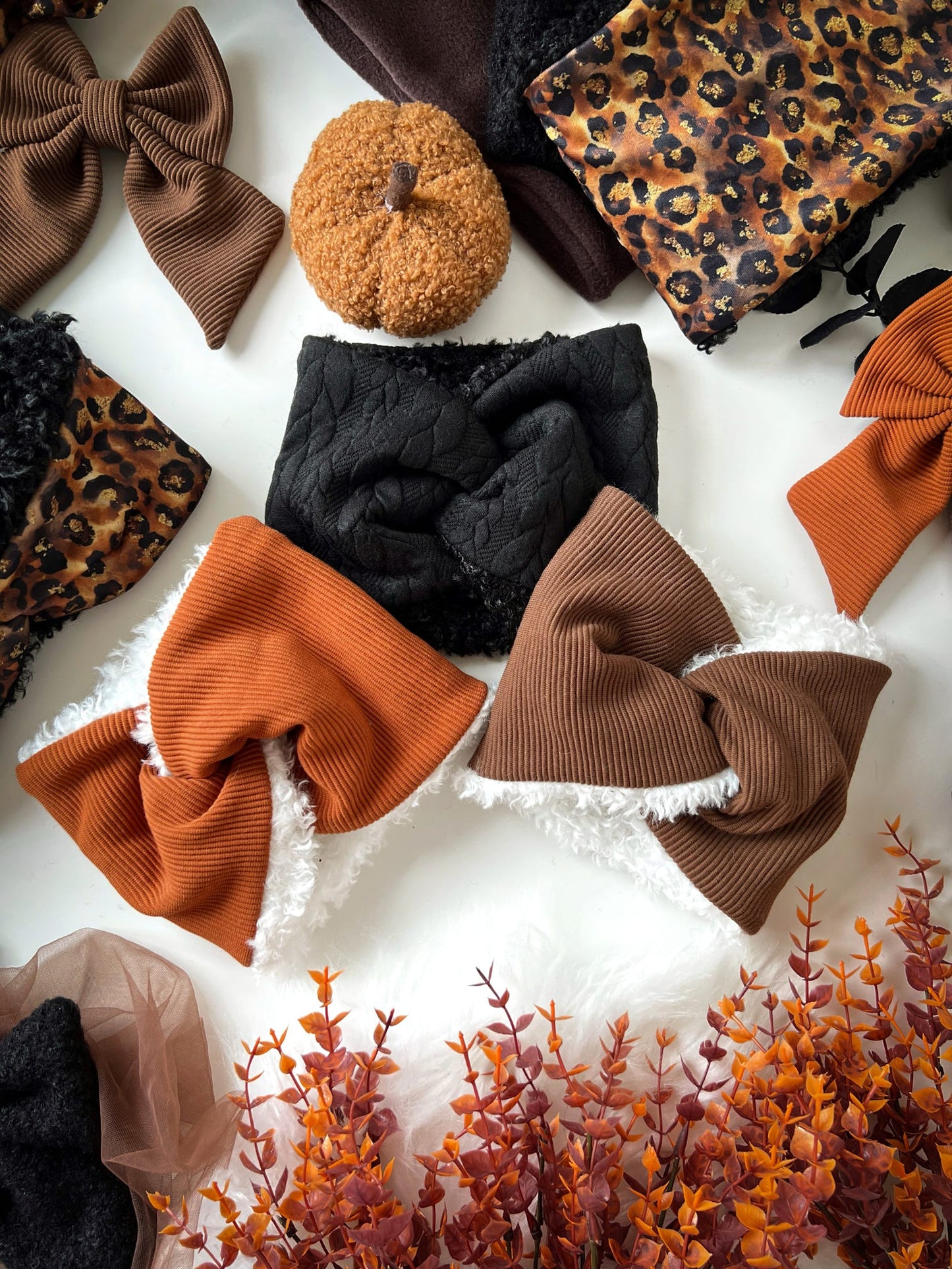 Collection of snoods, headband and bows on a white background