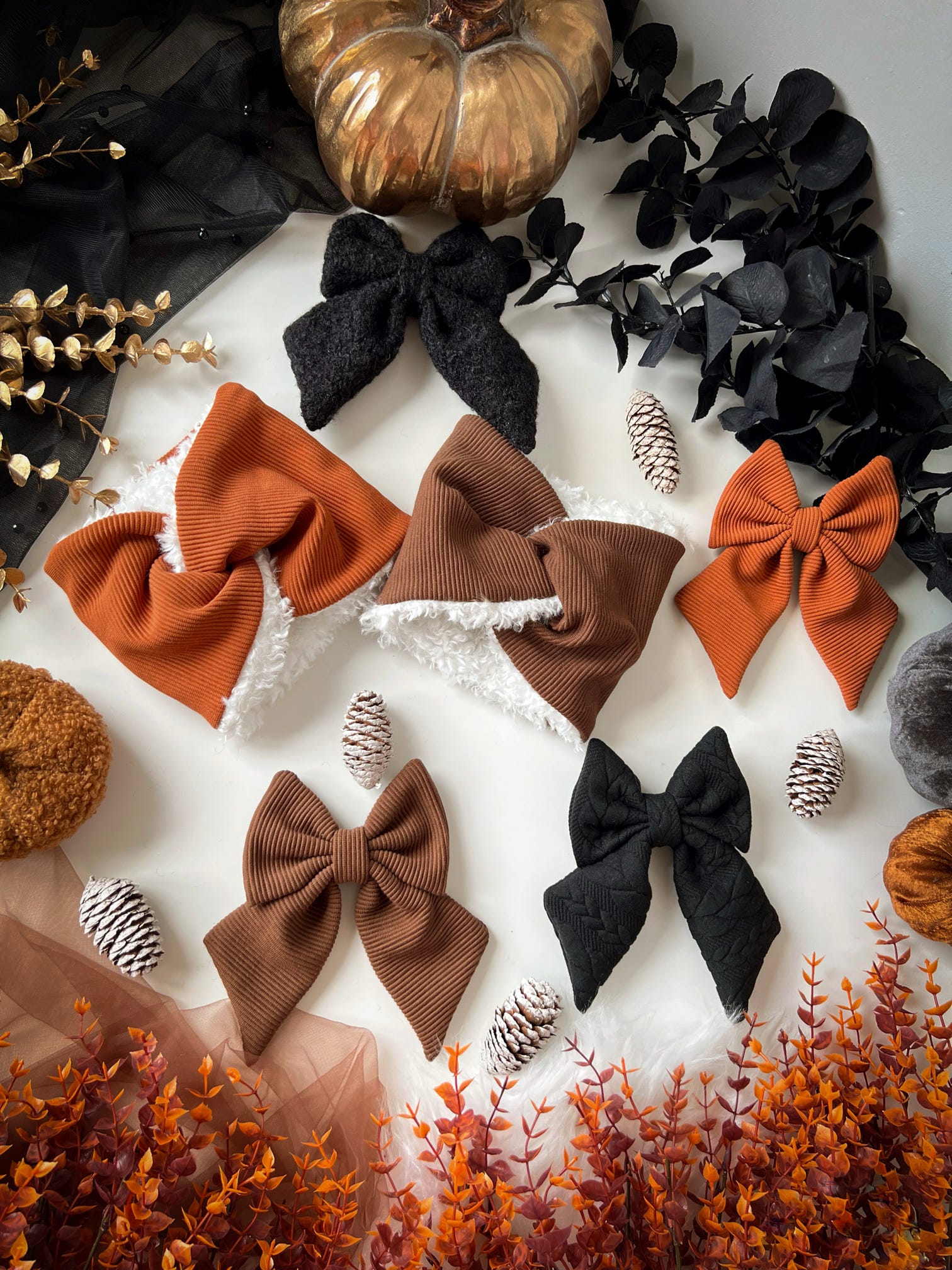 Collection of autumn-themed dog accessories with decorative elements on a white background